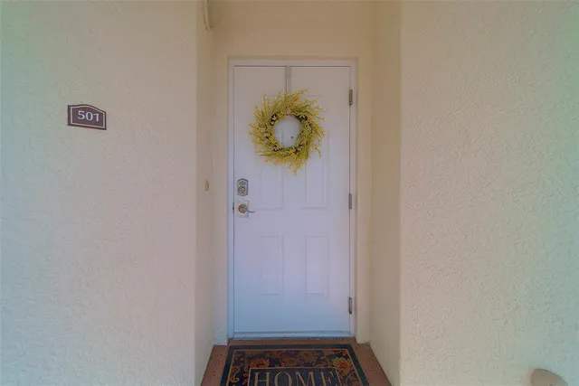 a kitchen with stainless steel appliances a sink a stove a refrigerator cabinets and a center island