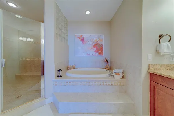 a bathroom with a sink a toilet and a large mirror