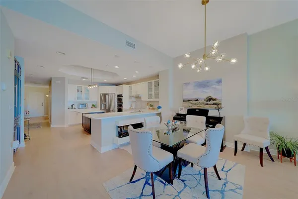a kitchen with white cabinets and black appliances