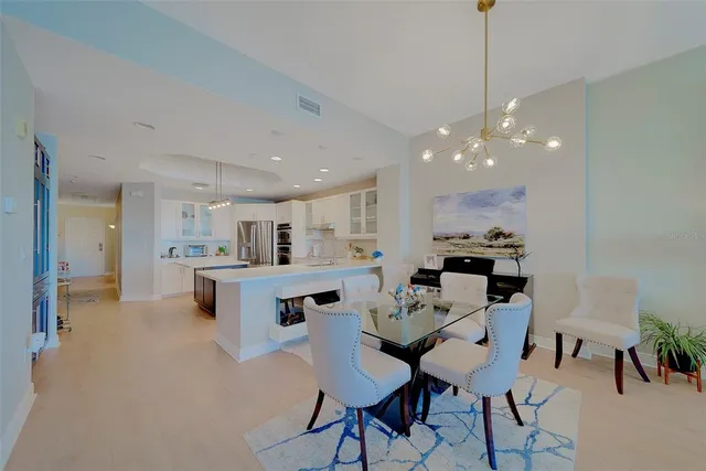 a kitchen with white cabinets and black appliances