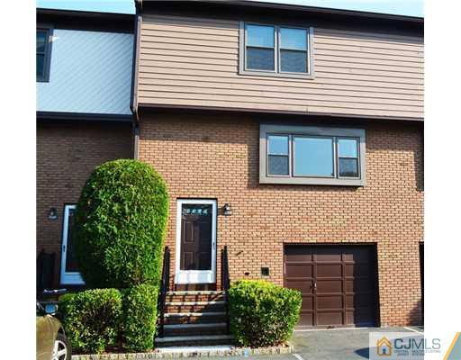 7103 Hana Road Edison, NJ 08817 - Photo 1 of 7 a front view of a house with garden