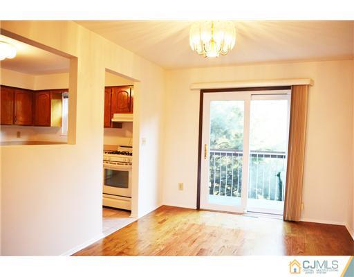 7103 Hana Road Edison, NJ 08817 - Photo 5 of 7 a view of a bedroom with wooden floor and a window