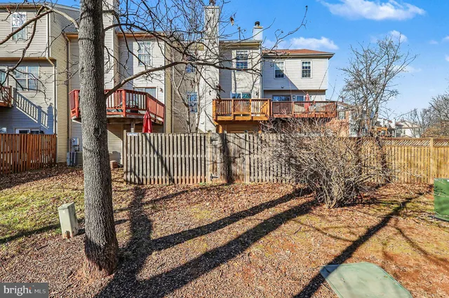 a view of a house with wooden fence
