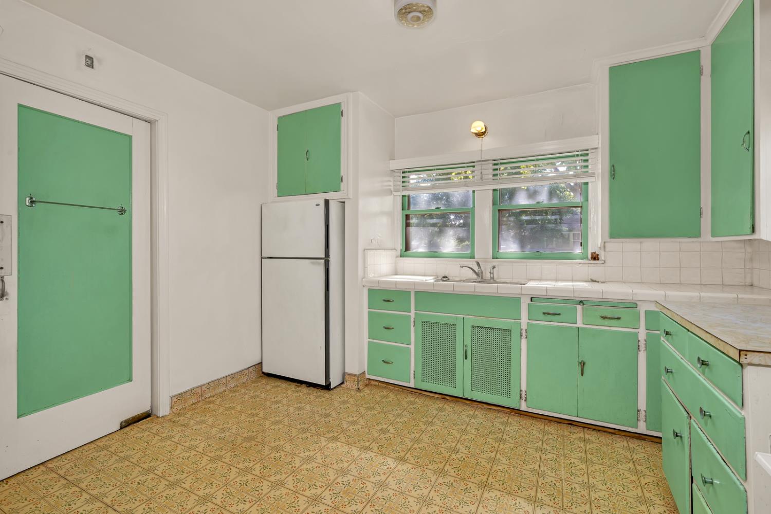 500 North G Street Madera, CA 93637 - Photo 12 of 24 a kitchen with a refrigerator and a sink