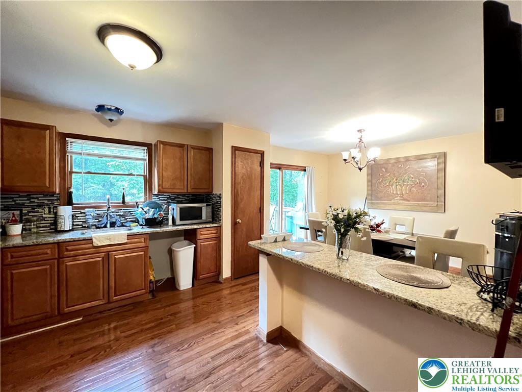 107 Warbler Court Bushkill, PA 18324 - Photo 13 of 32 a large kitchen with granite countertop a large counter top space a sink stainless steel appliances and cabinets