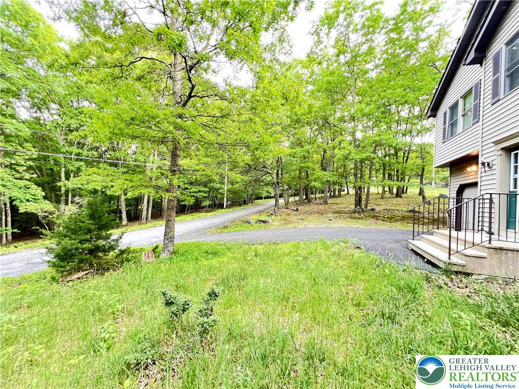 107 Warbler Court Bushkill, PA 18324 - Photo 7 of 32 a view of swimming pool with lawn chairs and plants