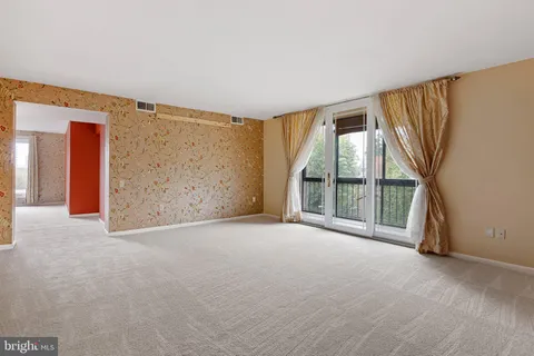 a view of an empty room with a large window