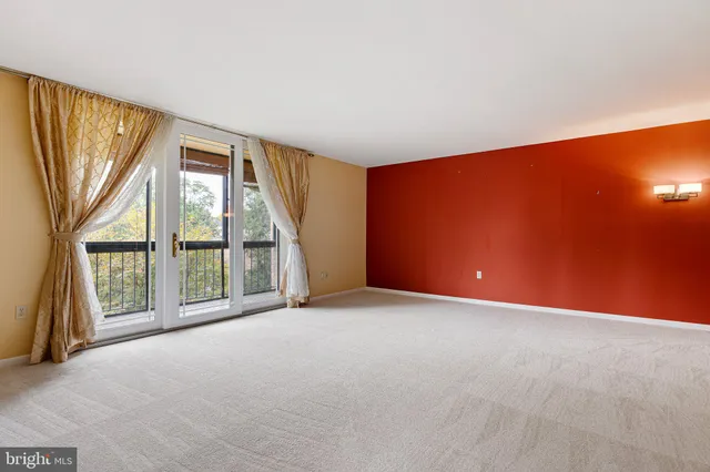 an empty room with windows and city view