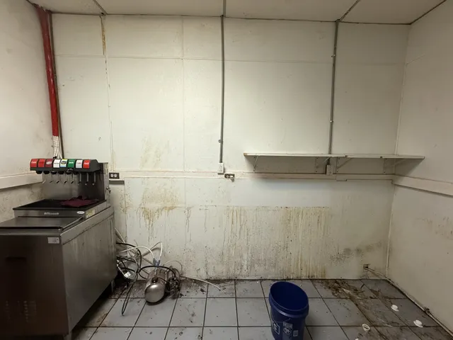 a bathroom with a granite countertop sink a toilet and a shower