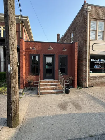a view of the house with door and outdoor seating