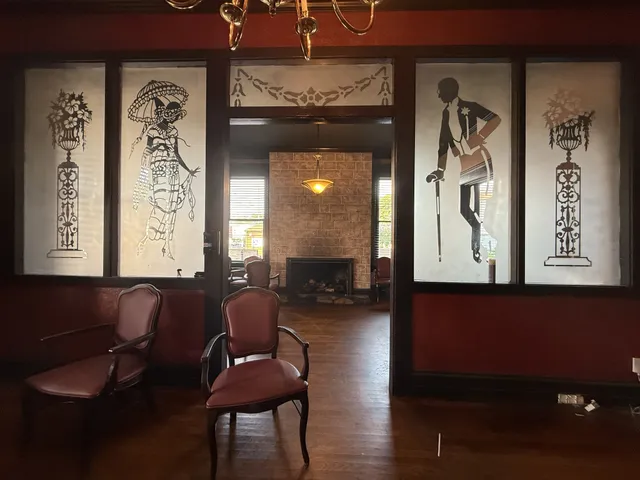 a living room with furniture and painting on the wall