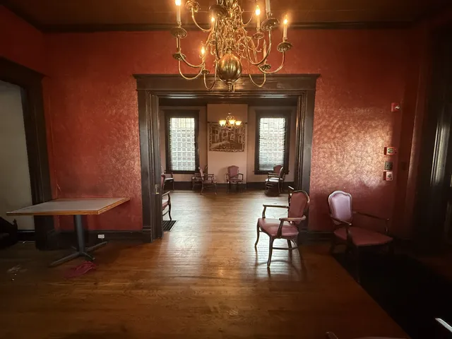 a view of a dining room with furniture and chandelier