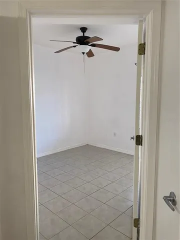 a view of a room with a ceiling fan