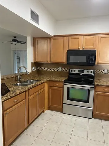 a kitchen with a stove and a sink