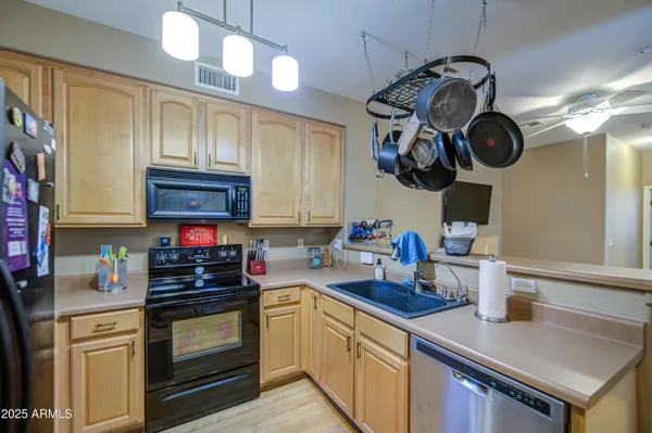 a kitchen with a stove and a wooden floor