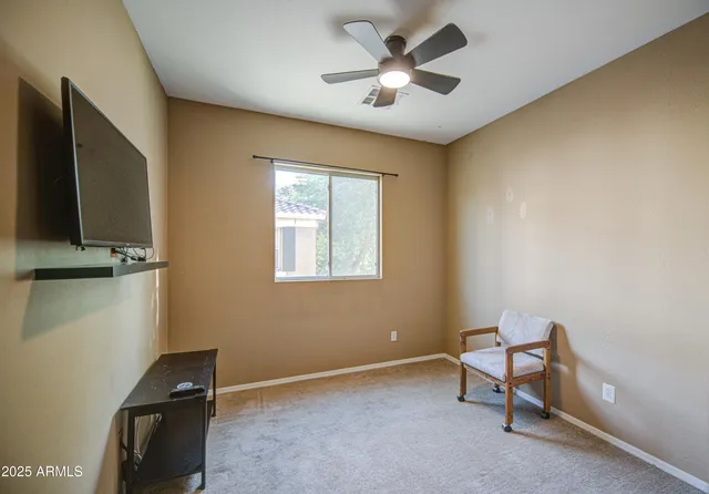 a bedroom with a bed and a tv