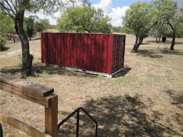 a view of a backyard with wooden fence