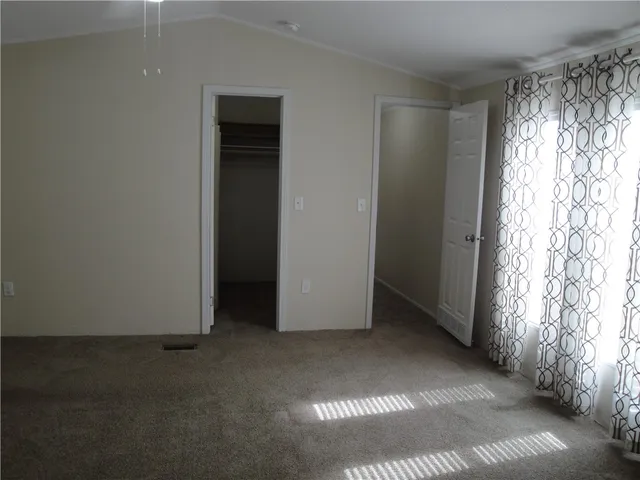 an empty room with windows and yard