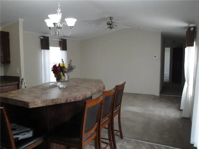 a view of a dining room with furniture and chandelier
