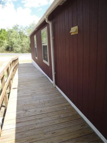 a view of a house with wooden floor and floor to ceiling window