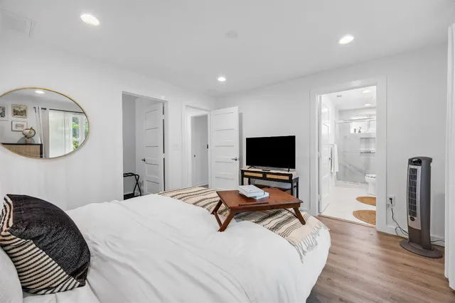 a bedroom with a bed and a flat screen tv