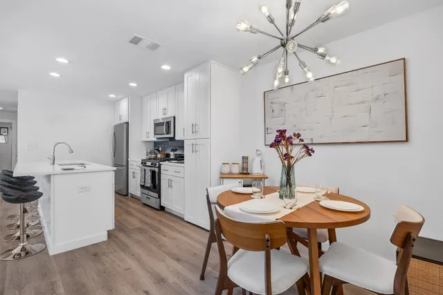 a view of a dining room with furniture and wooden floor
