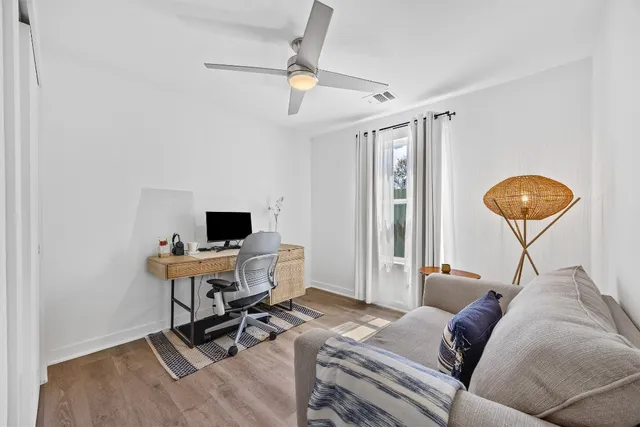 a living room with furniture and a wooden floor