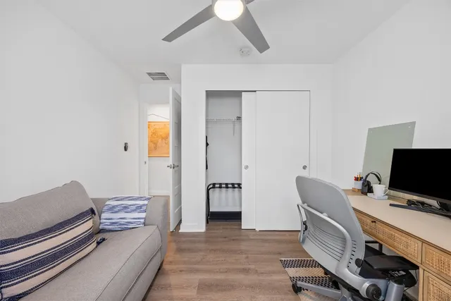 a bedroom with furniture and wooden floor