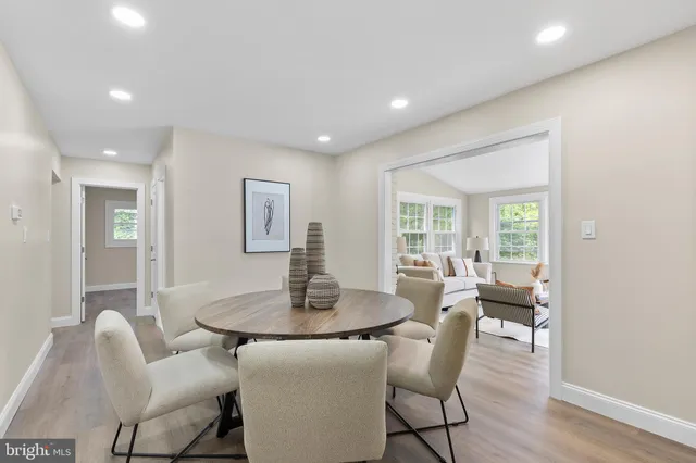 a dining room with furniture and wooden floor