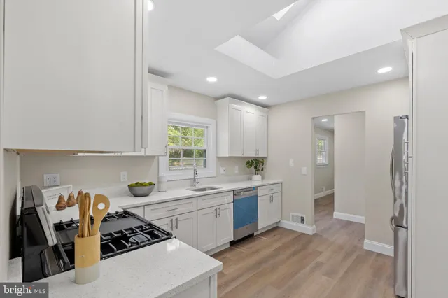 a kitchen with a sink a stove and refrigerator