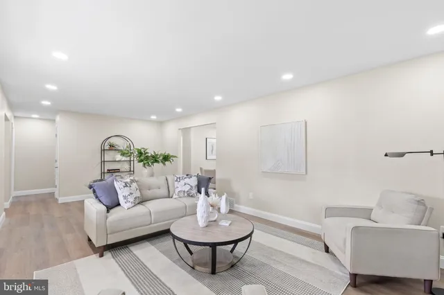 a living room with furniture and a mirror