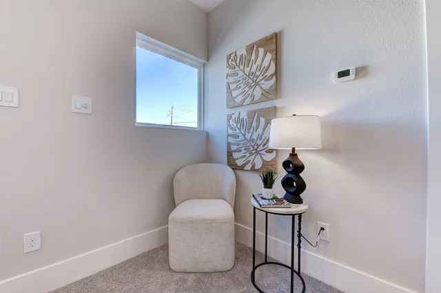 a table with a chair and painting on the wall
