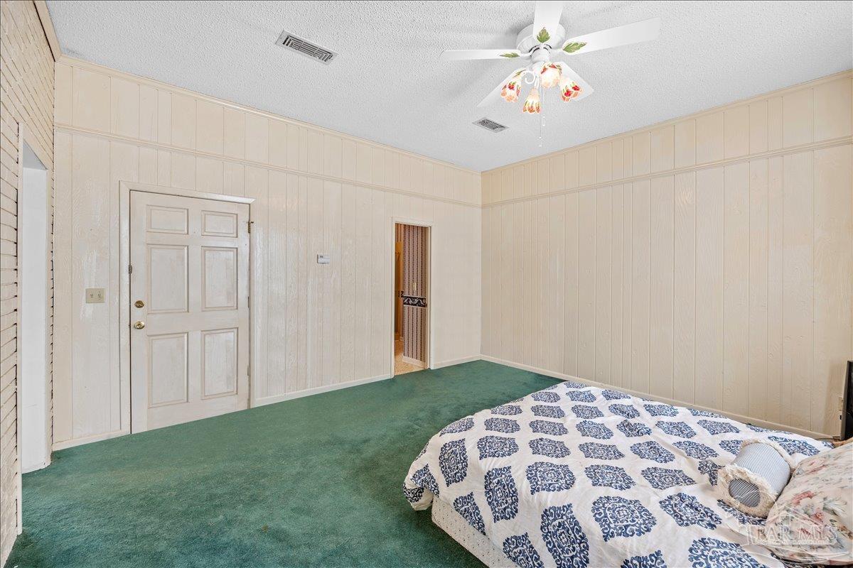 5560 Willard Norris Road Milton, FL 32570 - Photo 13 of 58 a bedroom with bed and a chandelier