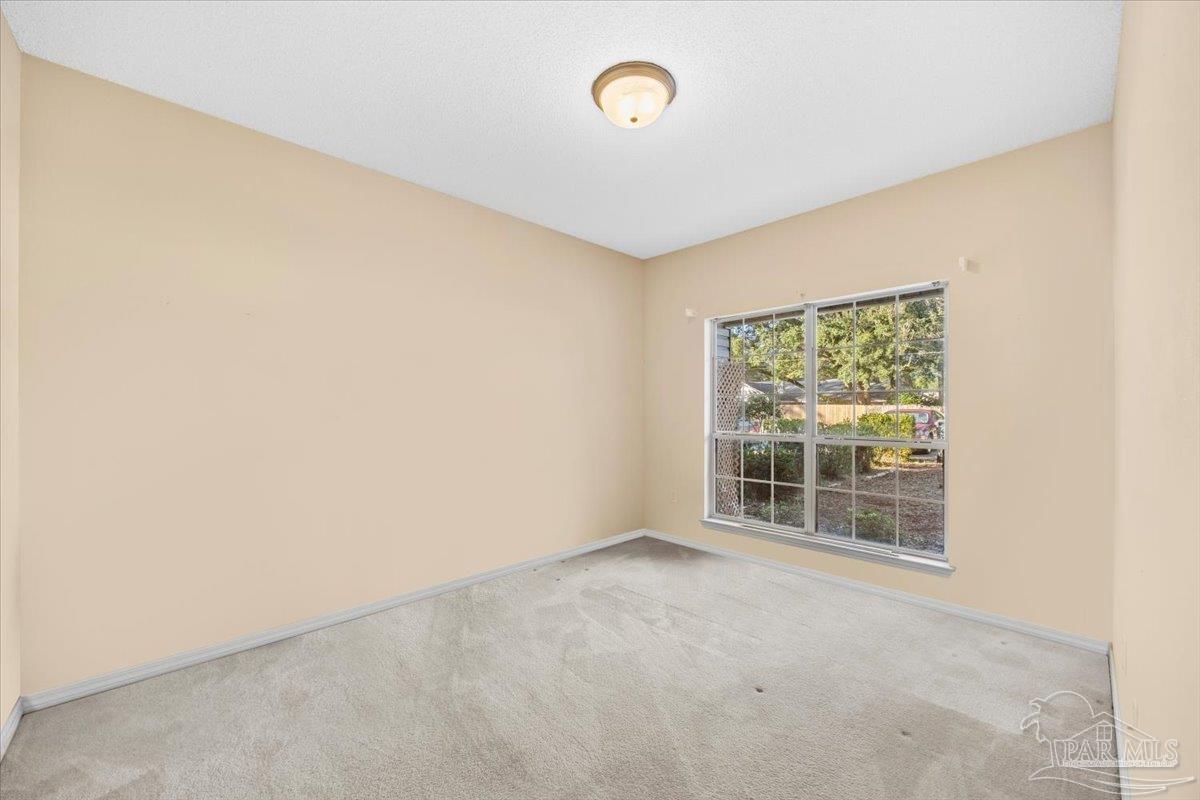 5560 Willard Norris Road Milton, FL 32570 - Photo 16 of 58 an empty room with a window