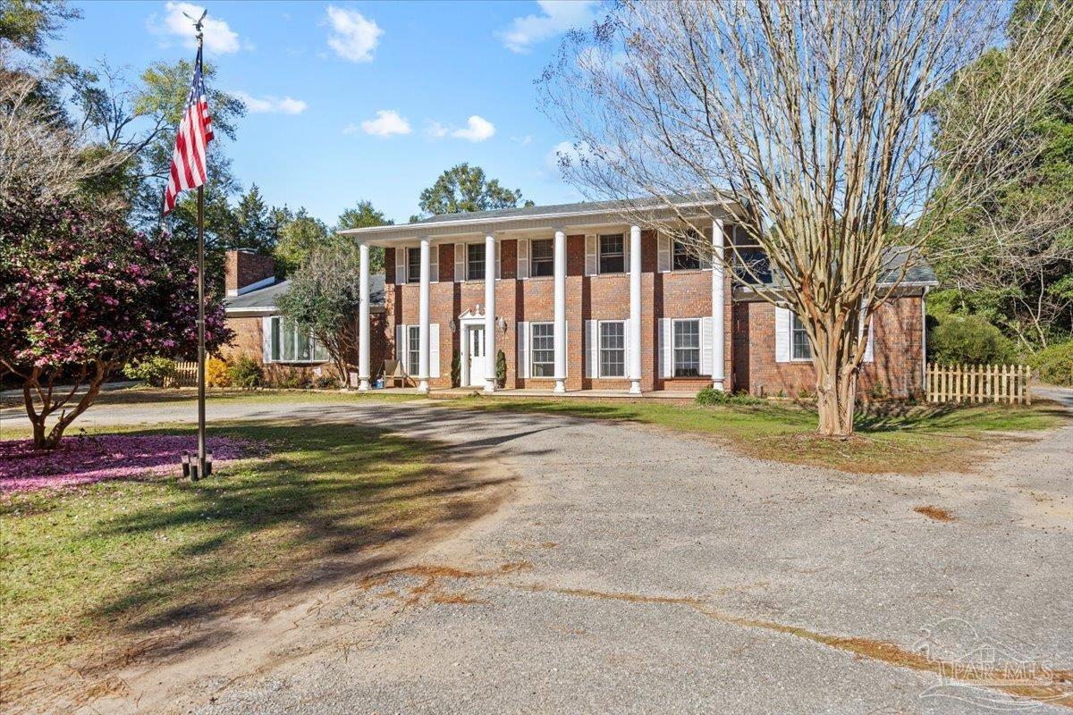 5560 Willard Norris Road Milton, FL 32570 - Photo 2 of 58 a view of a house with backyard and tree