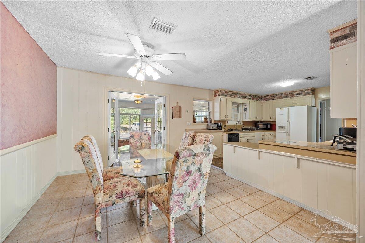 5560 Willard Norris Road Milton, FL 32570 - Photo 22 of 58 a view of a dining room with furniture and a chandelier