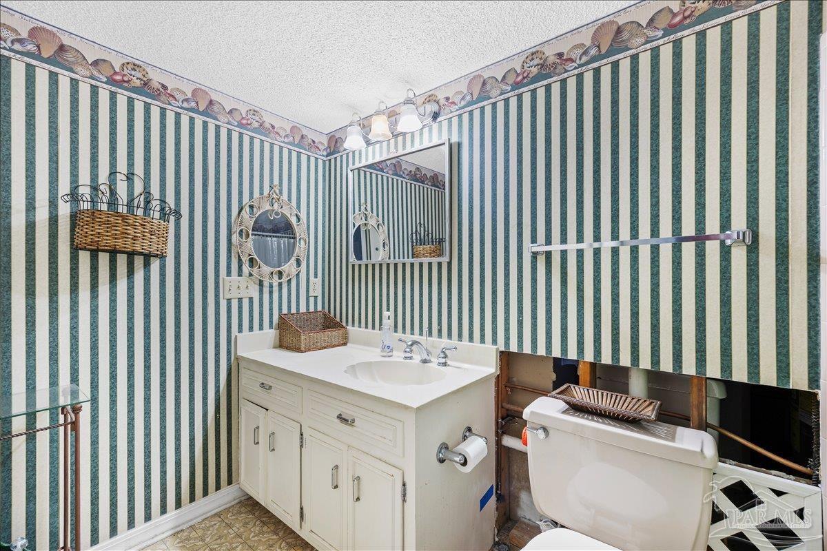 5560 Willard Norris Road Milton, FL 32570 - Photo 30 of 58 a bathroom with a sink and a mirror