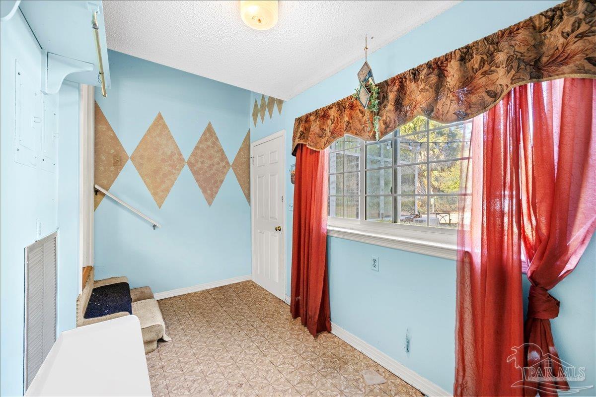 5560 Willard Norris Road Milton, FL 32570 - Photo 41 of 58 a view of walk in closet with clothes and shoes