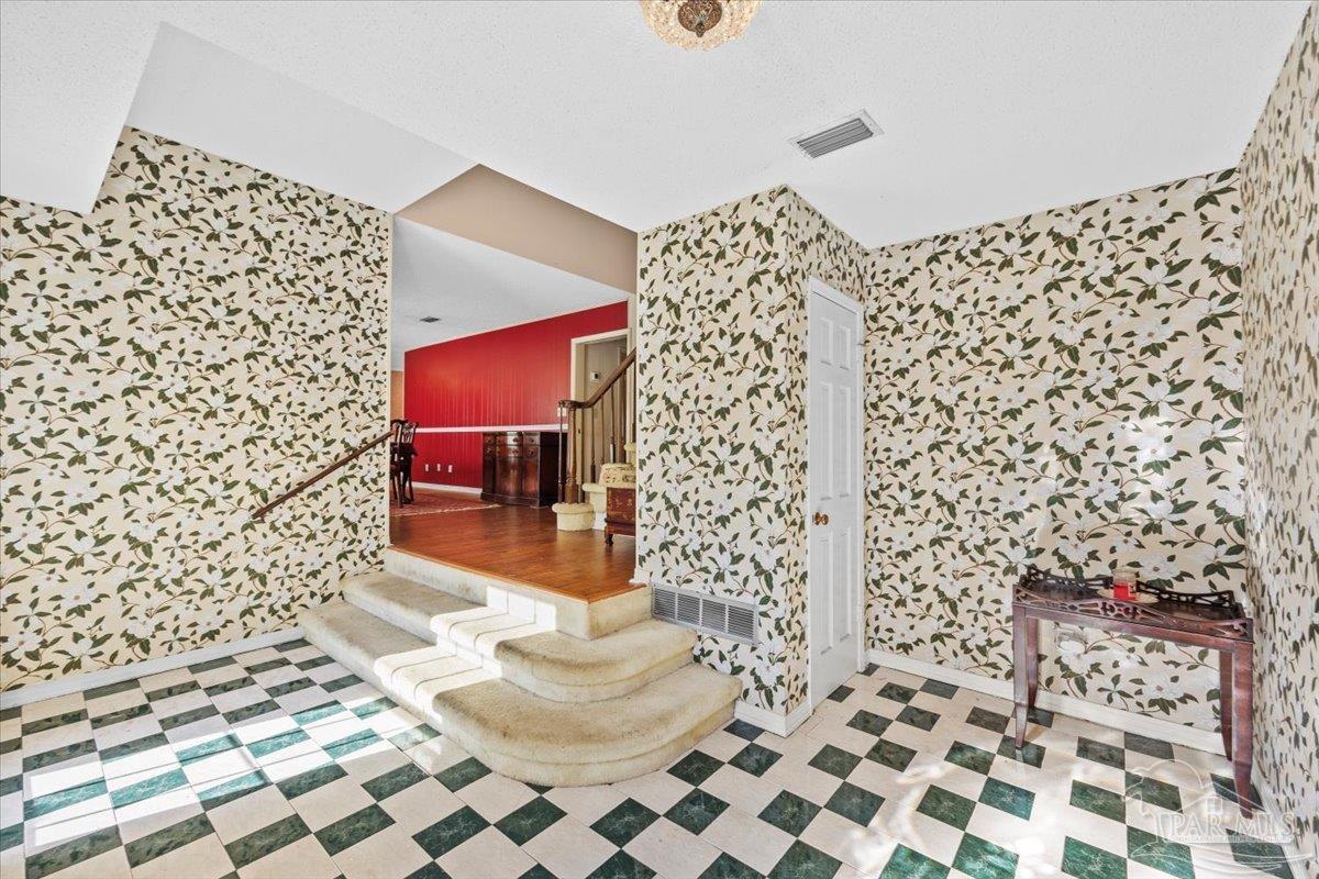 5560 Willard Norris Road Milton, FL 32570 - Photo 6 of 58 a bathroom with a toilet and a shower