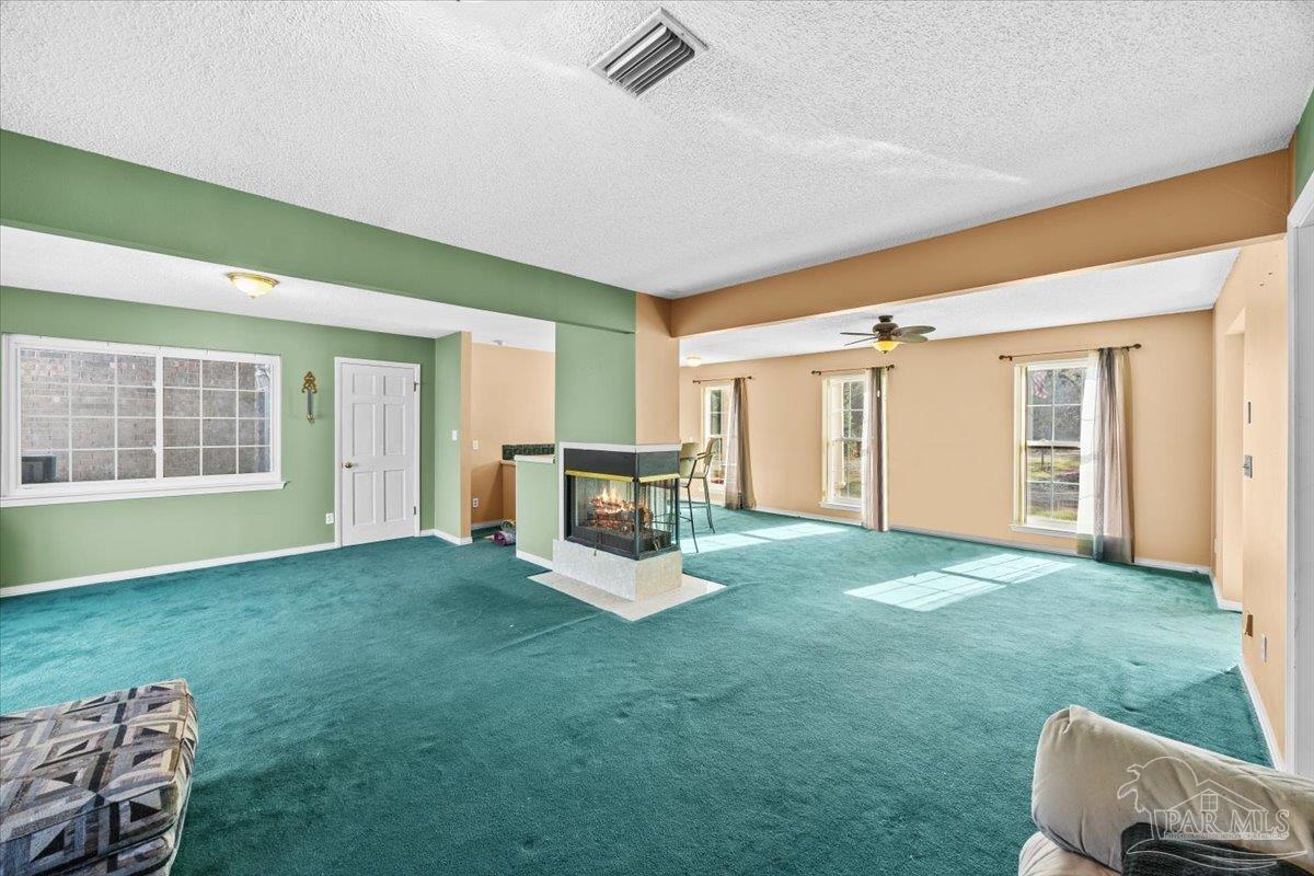 5560 Willard Norris Road Milton, FL 32570 - Photo 8 of 58 a view of a room with furniture and a yard