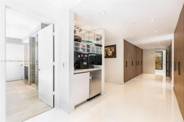 a view of a hallway with bathroom and shower