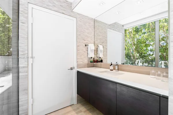 a bathroom with a double vanity sink and mirror