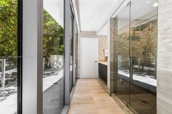 a bathroom with a glass shower door