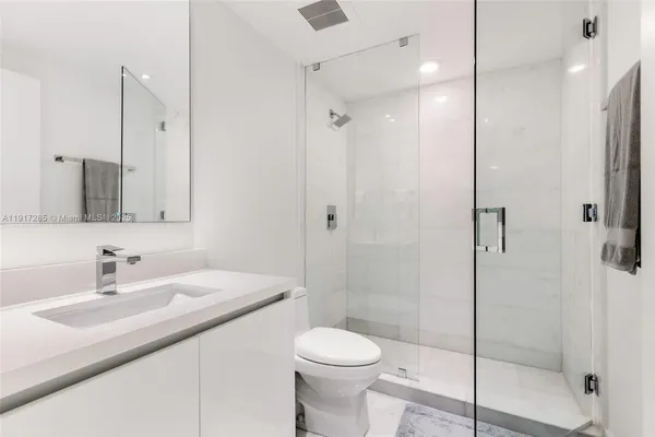 a bathroom with a sink toilet and shower