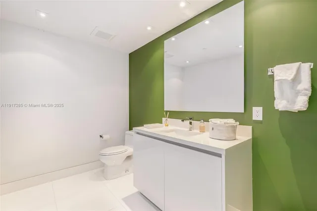 a bathroom with a sink toilet and mirror