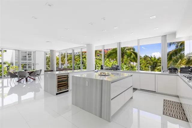 a large white kitchen with a large window