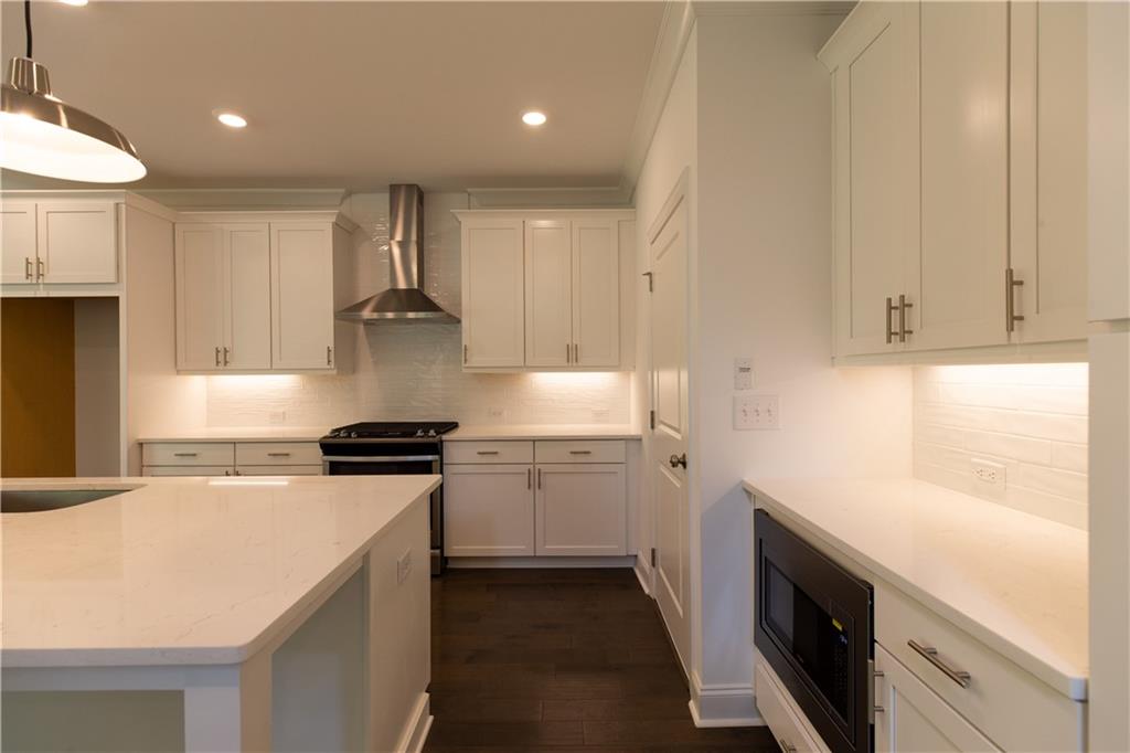 4912 Molder Avenue, Unit 66 Buford, GA 30518 - Photo 12 of 83 a kitchen with a sink stove and cabinets