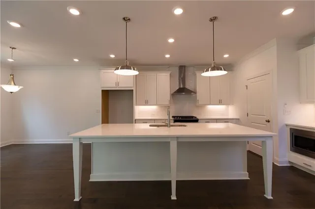 a kitchen with stainless steel appliances a stove a sink and a refrigerator