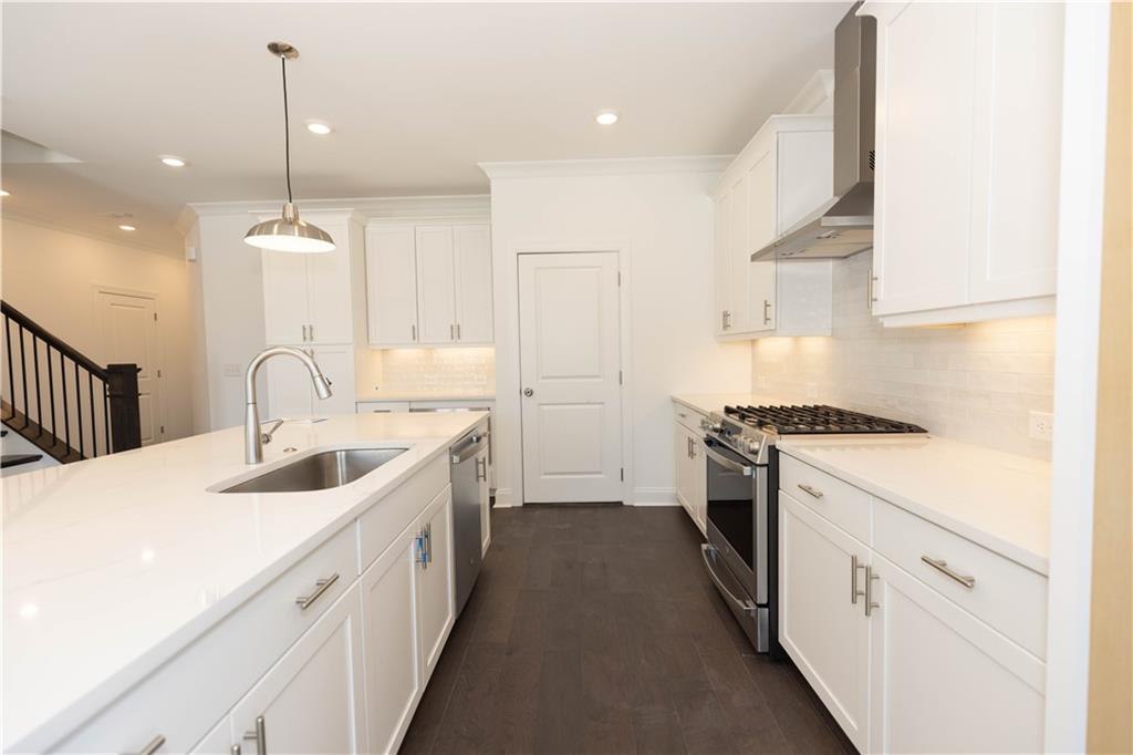4912 Molder Avenue, Unit 66 Buford, GA 30518 - Photo 21 of 83 a kitchen with white cabinets appliances and a sink