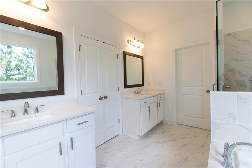 4912 Molder Avenue, Unit 66 Buford, GA 30518 - Photo 36 of 83 a bathroom with a double vanity sink mirror and